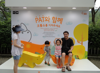  서울대공원을 찾은 가족이 코뿔소 모금함에 기금을 넣은 뒤 사진촬영을 하고 있다.