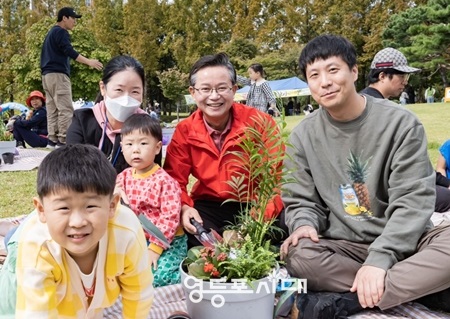 ▲ 최호권 영등포구청장(가운데)이 7일, 영등포공원에서 열린 ‘유아숲 가족축제’ 현장을 찾아 참여 가족들과 함께 기념사진을 찍고 있다./이미지=영등포구 제공